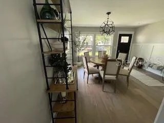 a view of a dining room with furniture and chandelier