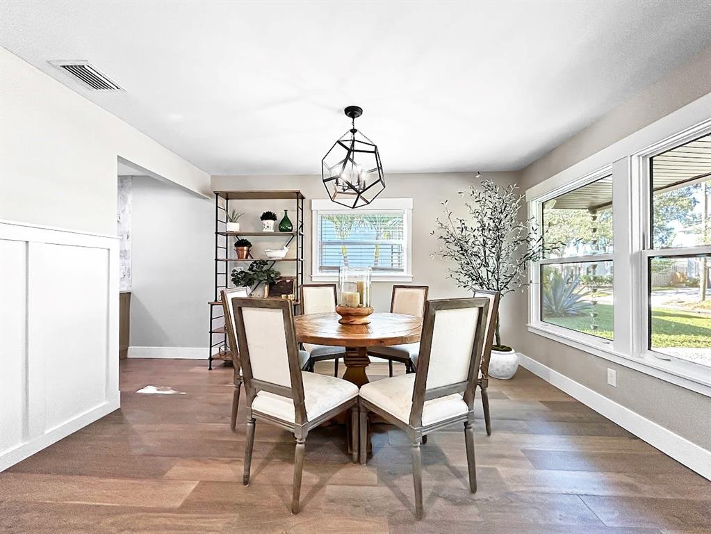 2908 West San Rafael Street Tampa, FL 33629 - Photo 13 of 27 a dining room with wooden floor a chandelier a wooden table and chairs