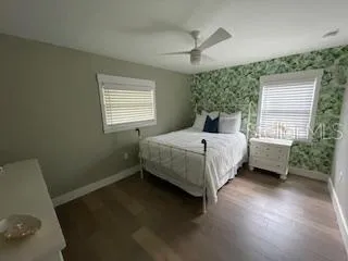 a bedroom with a bed dresser and a window