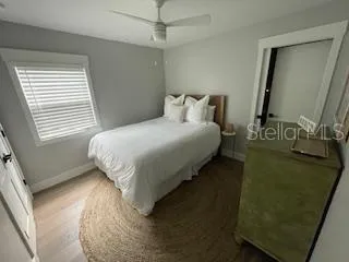 a bathroom with a granite countertop toilet a sink a shower and a mirror