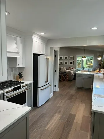 a kitchen with a refrigerator and a sink