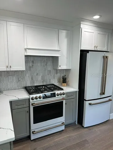 a kitchen with a stove and a refrigerator