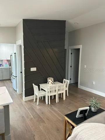 a view of a dining room with furniture and wooden floor