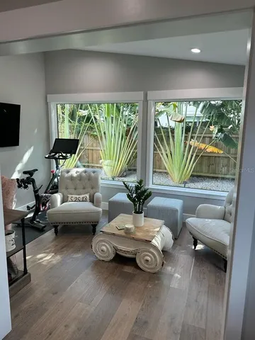 a living room with furniture and a large window