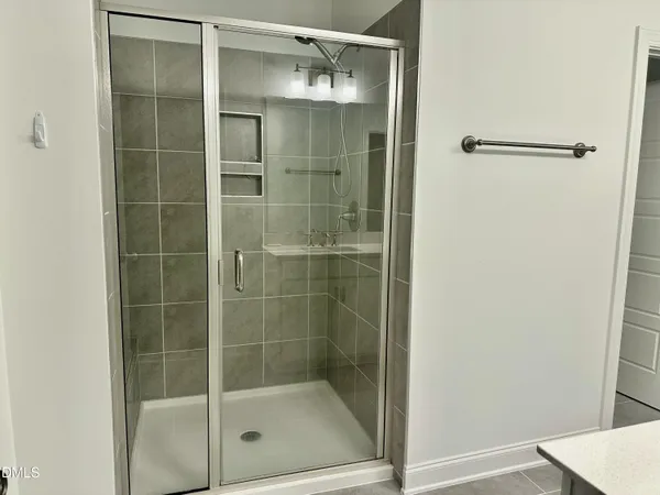 a bathroom with a glass shower door