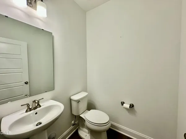 a bathroom with a sink mirror and toilet