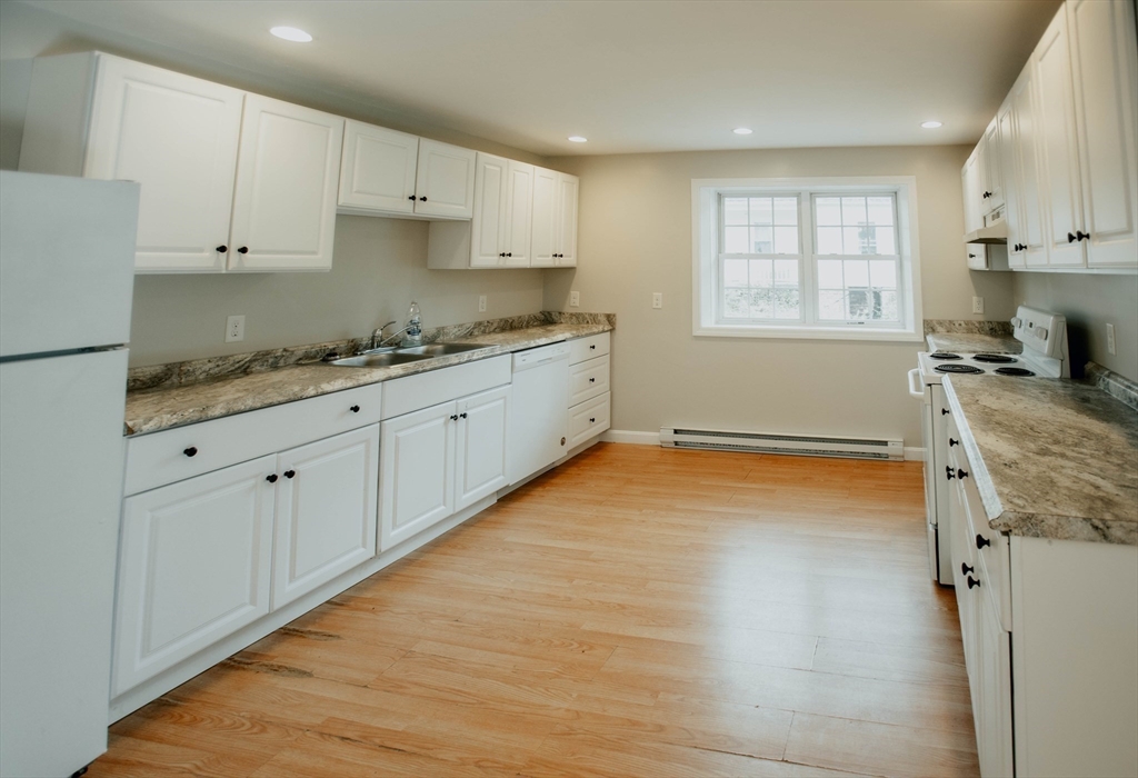 27 Kendall Street Barre, MA 01005 - Photo 13 of 40 a kitchen with granite countertop white cabinets and window