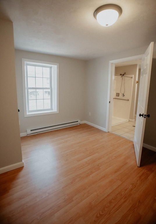 27 Kendall Street Barre, MA 01005 - Photo 19 of 40 an empty room with wooden floor and a window