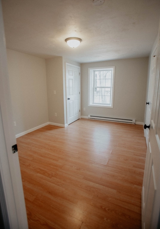 27 Kendall Street Barre, MA 01005 - Photo 20 of 40 a view of an empty room with wooden floor and a window