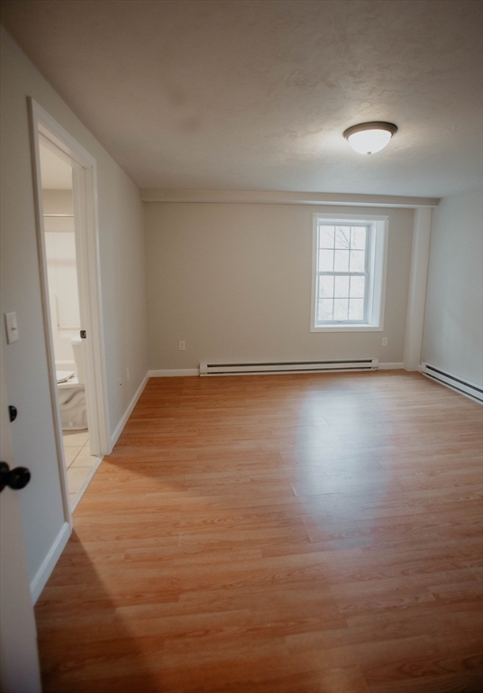 27 Kendall Street Barre, MA 01005 - Photo 21 of 40 an empty room with wooden floor and windows