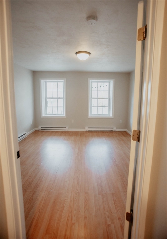 27 Kendall Street Barre, MA 01005 - Photo 27 of 40 an empty room with wooden floor and windows