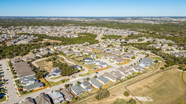 an aerial view of residential building and ocean