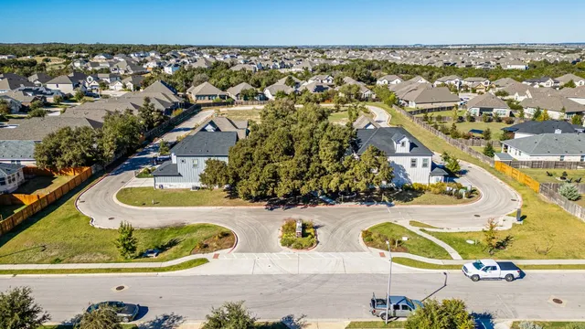 an aerial view of residential houses with outdoor space