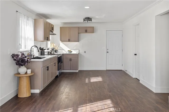 a kitchen with a sink a counter top space and cabinets