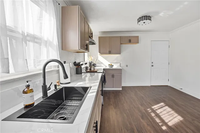 a kitchen with a sink stove and cabinets
