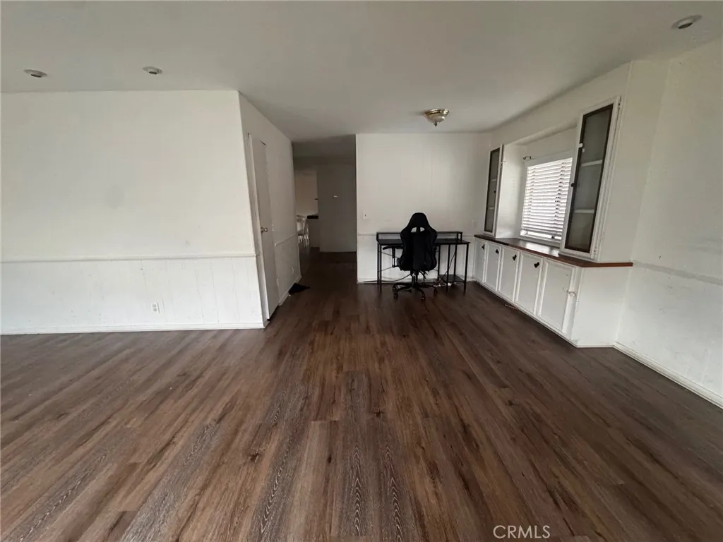 17701 South Avalon, Unit 81 Carson, CA 90746 - Photo 5 of 26 a view of an empty room with wooden floor and a window