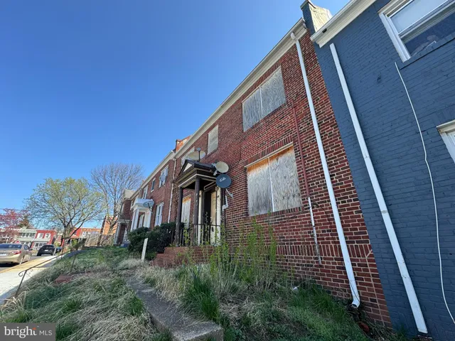 a view of a brick building next to a yard