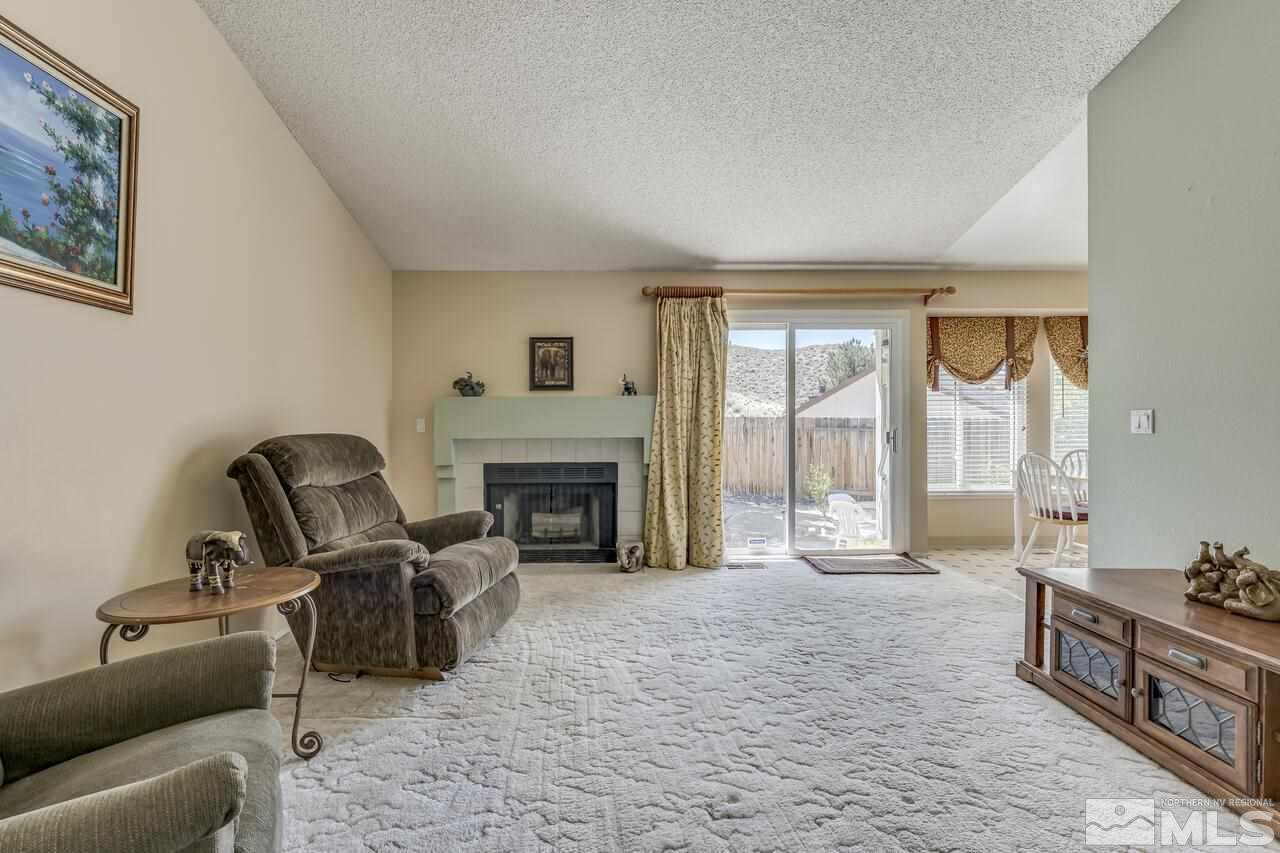 5490 Simons Drive Reno, NV 89523 - Photo 11 of 37 a living room with furniture and a fireplace