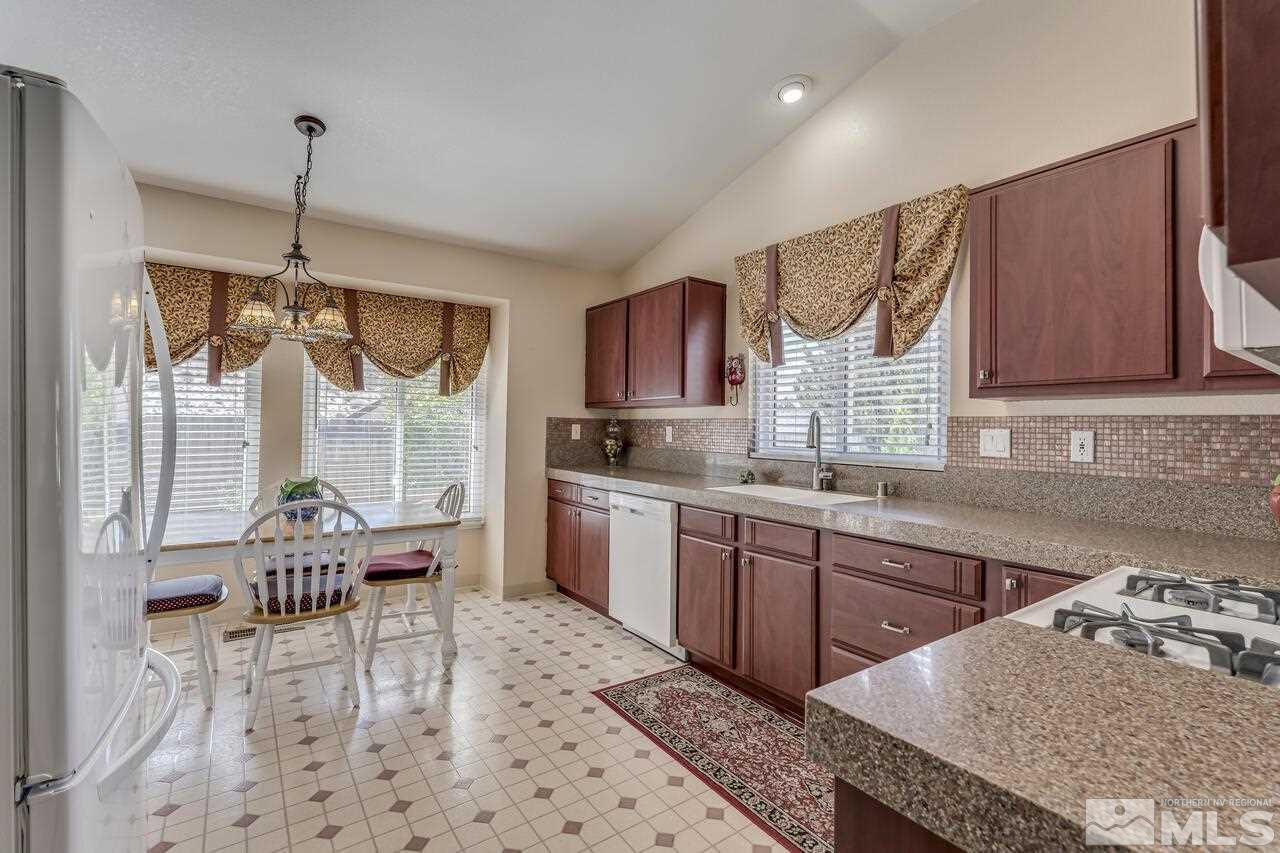 5490 Simons Drive Reno, NV 89523 - Photo 16 of 37 a kitchen with granite countertop a sink cabinets and window