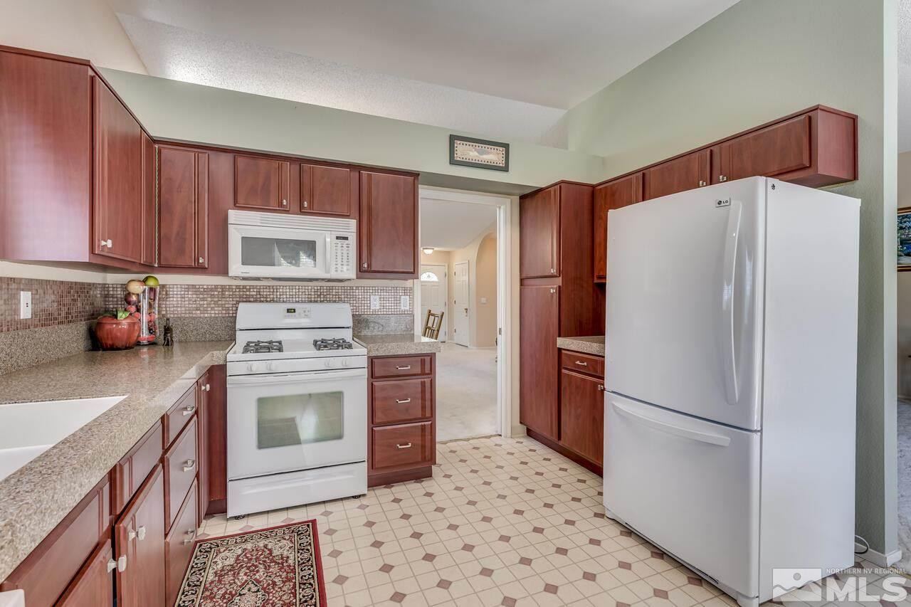 5490 Simons Drive Reno, NV 89523 - Photo 19 of 37 a kitchen with a refrigerator sink and stove