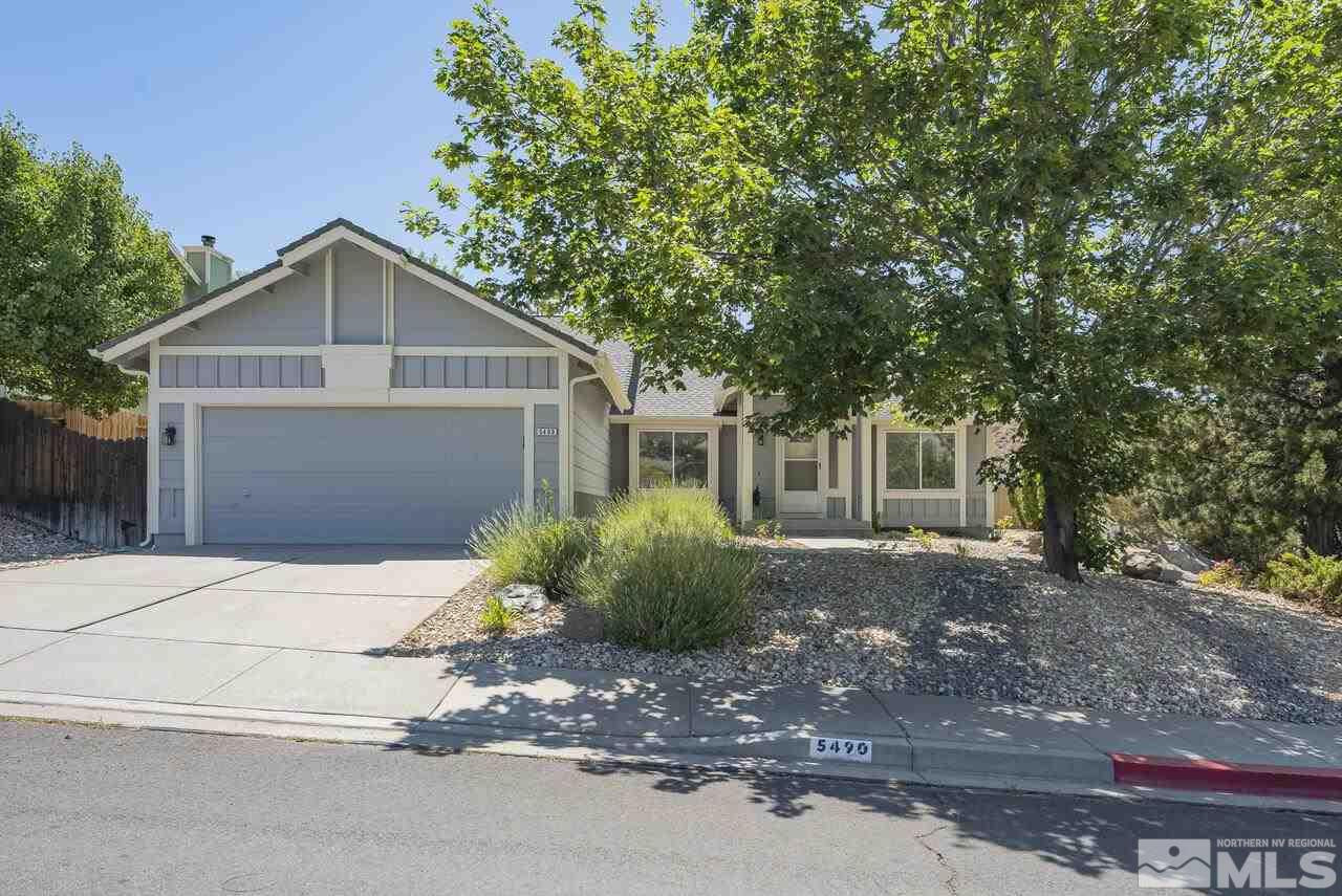 5490 Simons Drive Reno, NV 89523 - Photo 2 of 37 a front view of a house with a yard and garage