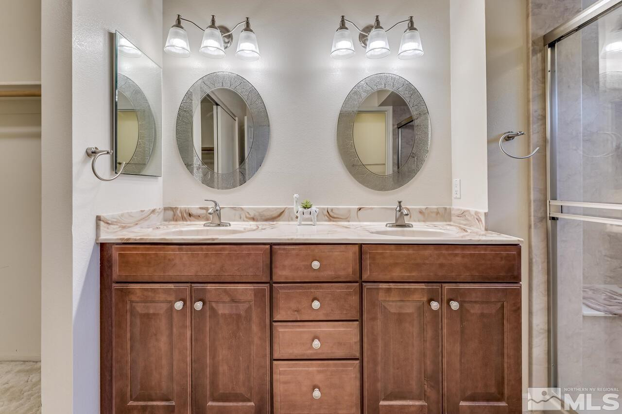 5490 Simons Drive Reno, NV 89523 - Photo 23 of 37 a bathroom with a double vanity sink and a mirror