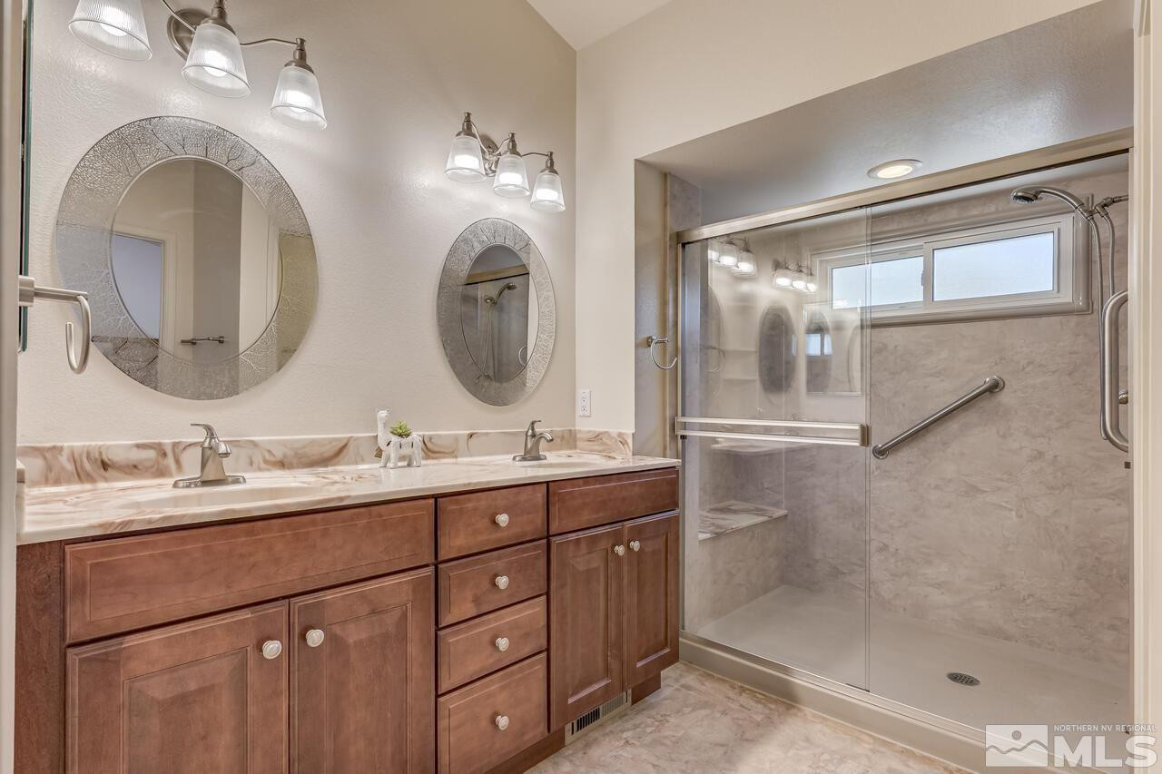 5490 Simons Drive Reno, NV 89523 - Photo 24 of 37 a bathroom with a double vanity sink and a mirror