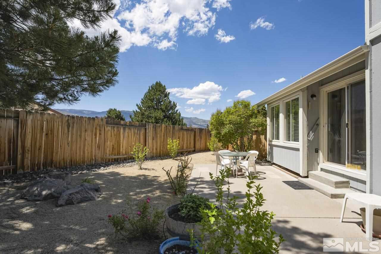 5490 Simons Drive Reno, NV 89523 - Photo 35 of 37 a backyard of a house with table and chairs with wooden fence