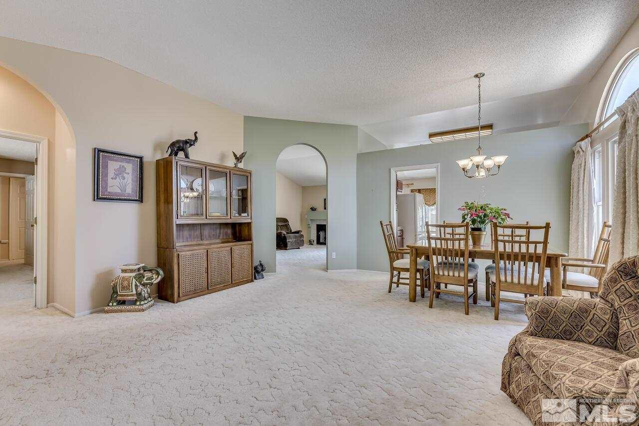 5490 Simons Drive Reno, NV 89523 - Photo 9 of 37 a living room with furniture a dining table and a large window