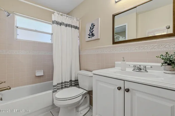 a bathroom with a sink toilet tub and shower