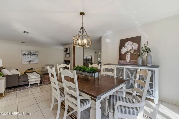 a view of a dining room with furniture and chandelier