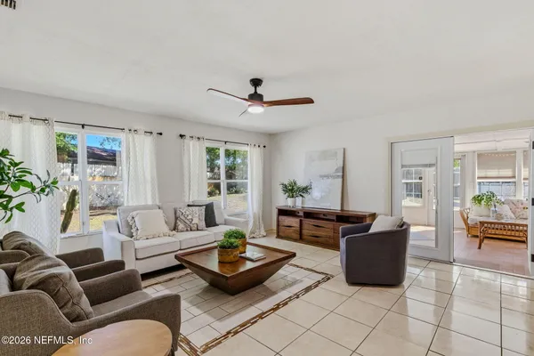 a living room with furniture a rug and a chandelier
