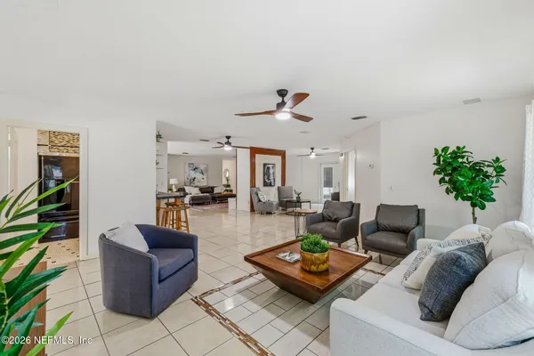 a living room with furniture and wooden floor