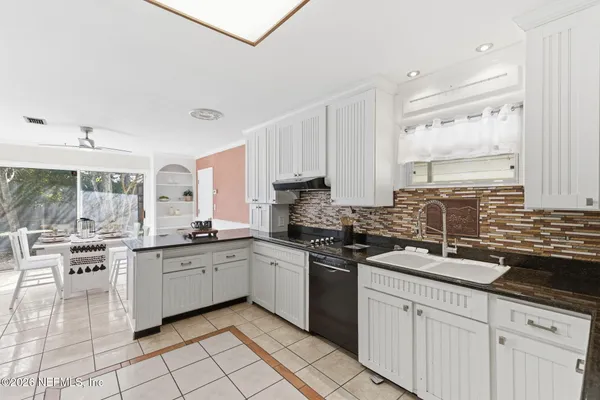 a kitchen with a sink stove and cabinets