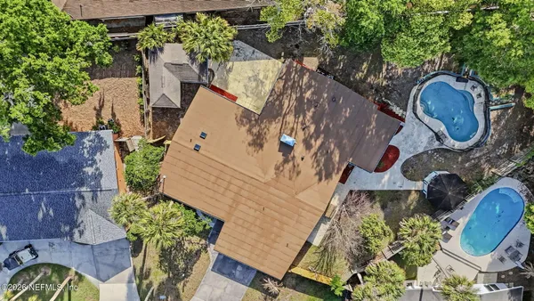 an aerial view of a house with table and chairs