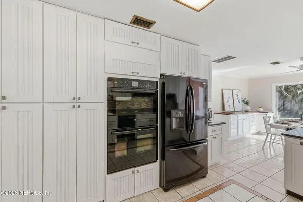 a kitchen with stainless steel appliances a refrigerator and cabinets