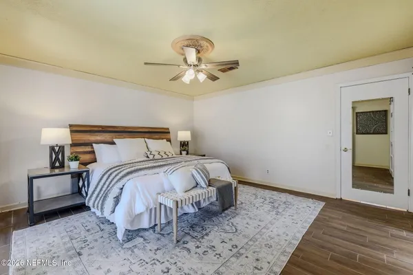 a bedroom with a bed and a chandelier