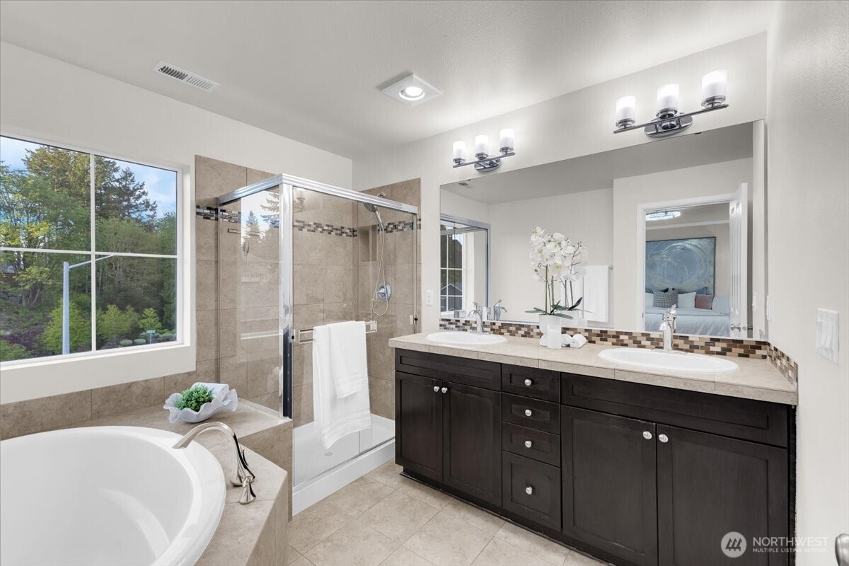 3532 202nd Pl S East Bothell, WA 98012 - Photo 20 of 39 a spacious bathroom with a double vanity sink a large mirror and shower