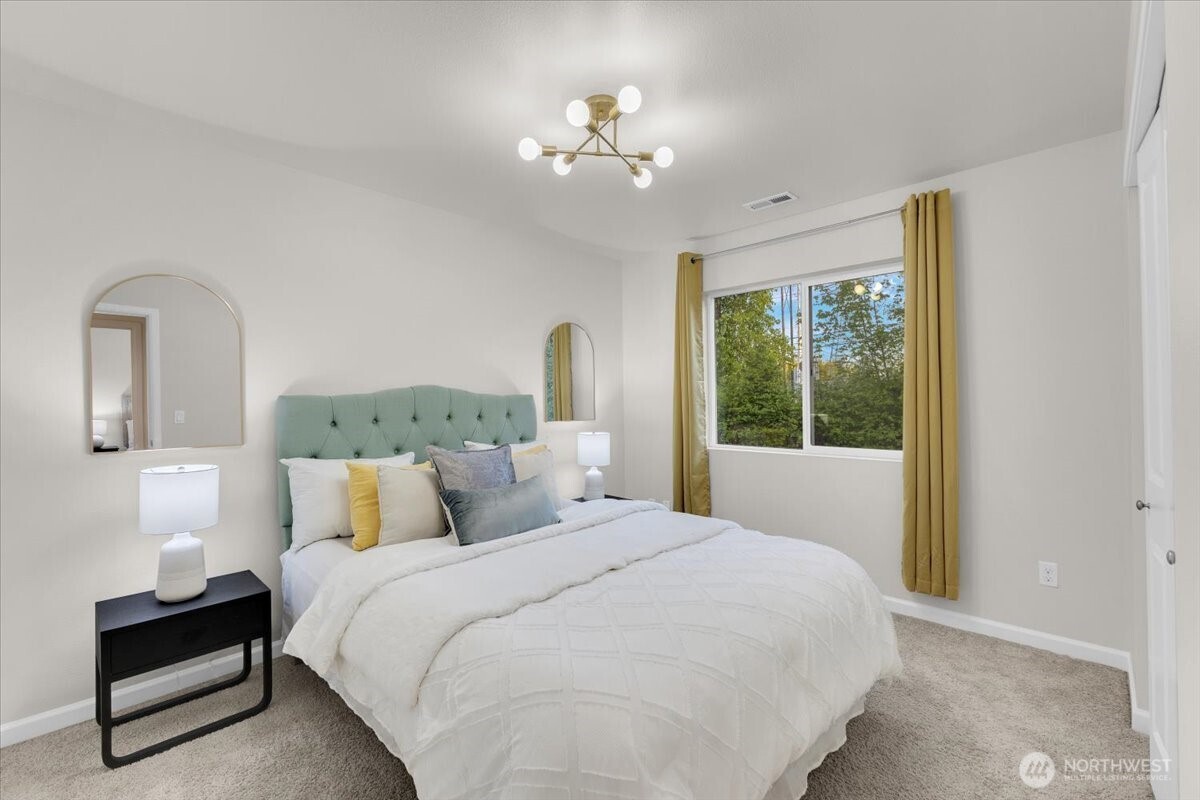 3532 202nd Pl S East Bothell, WA 98012 - Photo 24 of 39 a bedroom with a large bed and a chandelier