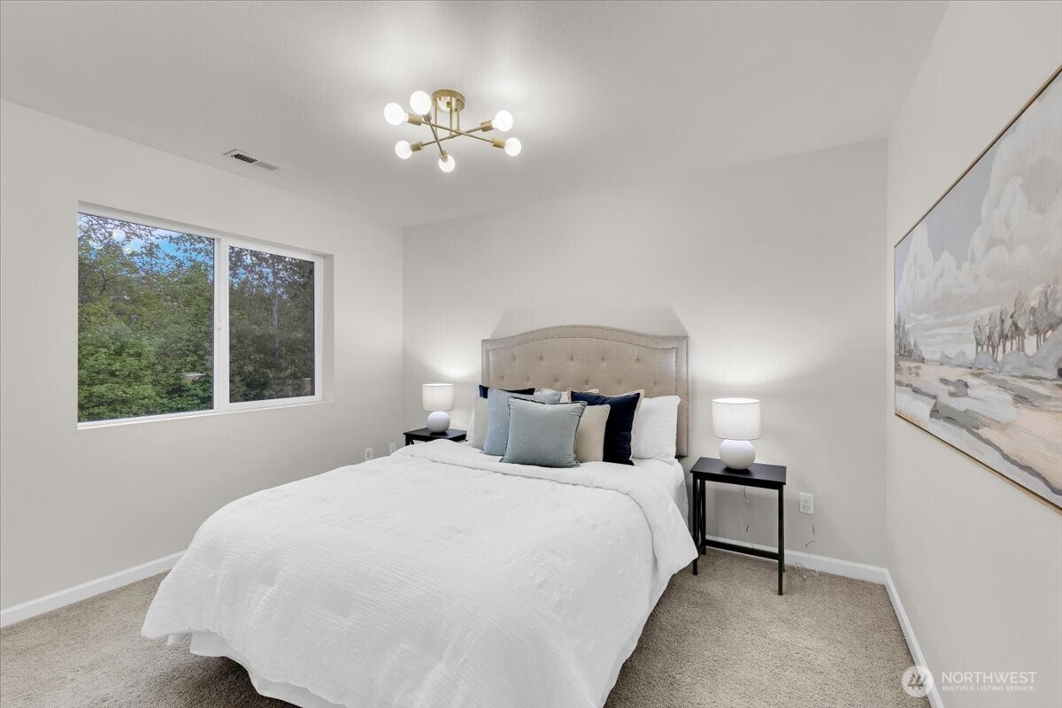 3532 202nd Pl S East Bothell, WA 98012 - Photo 26 of 39 a bedroom with a large bed and a chandelier