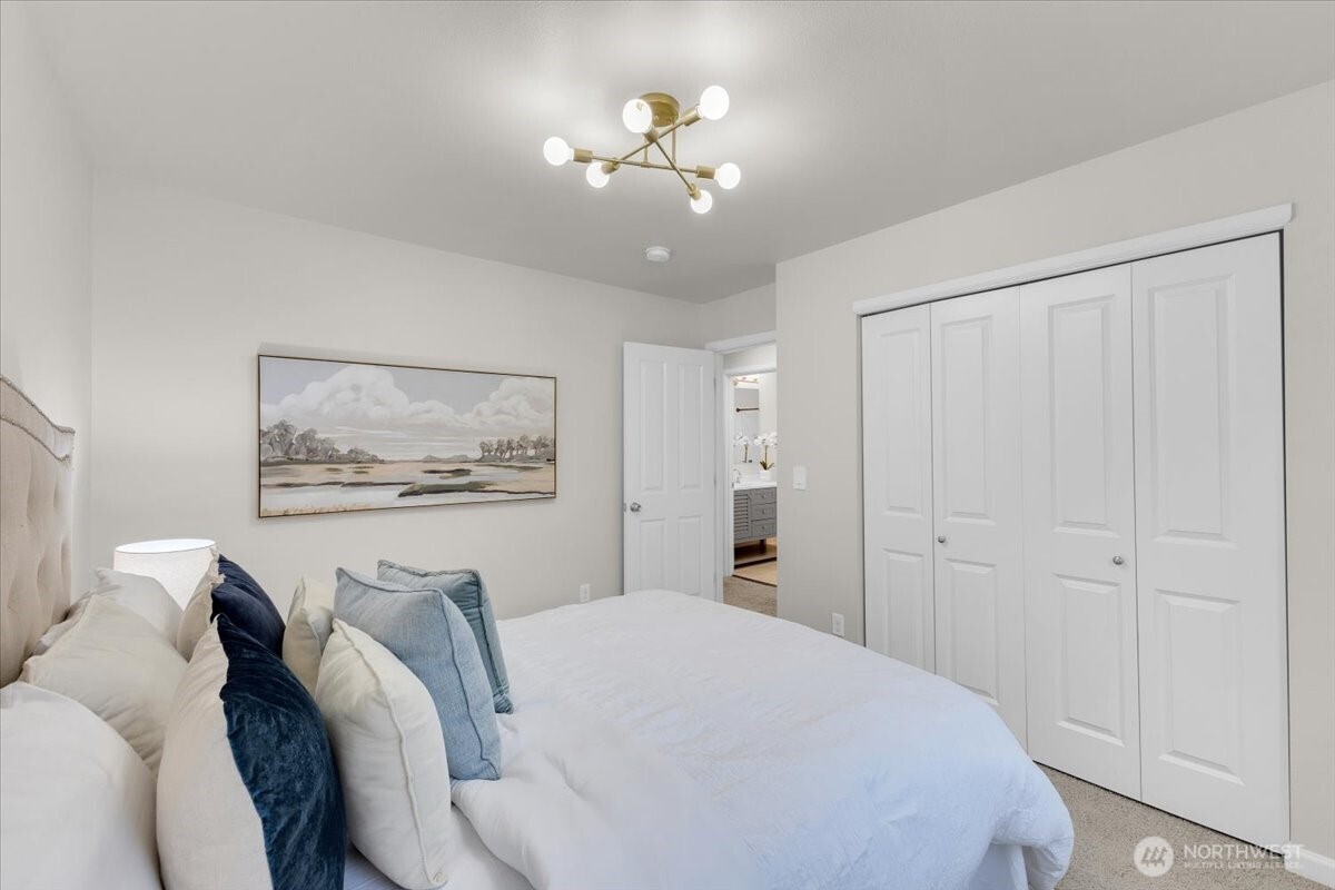 3532 202nd Pl S East Bothell, WA 98012 - Photo 27 of 39 a bedroom with a bed and a chandelier