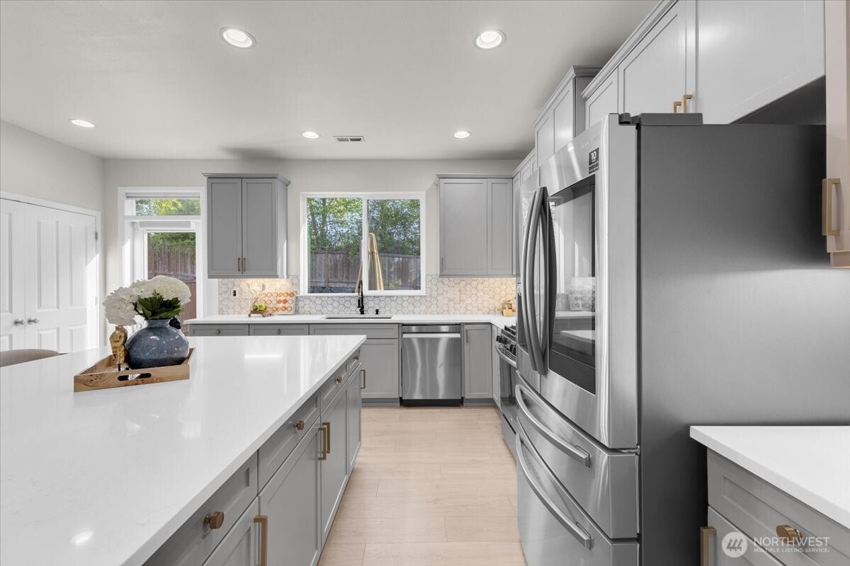 3532 202nd Pl S East Bothell, WA 98012 - Photo 10 of 39 a kitchen with stainless steel appliances granite countertop a refrigerator and a sink