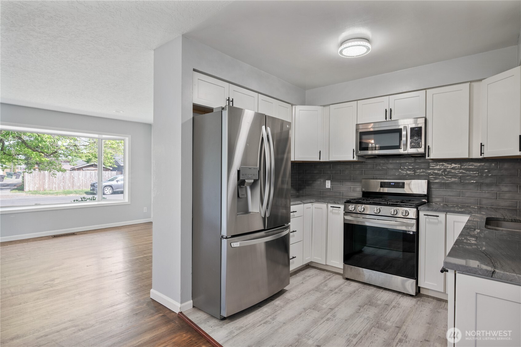 2017 28th Avenue Longview, WA 98632 - Photo 11 of 37 a kitchen with a stove a microwave and a refrigerator