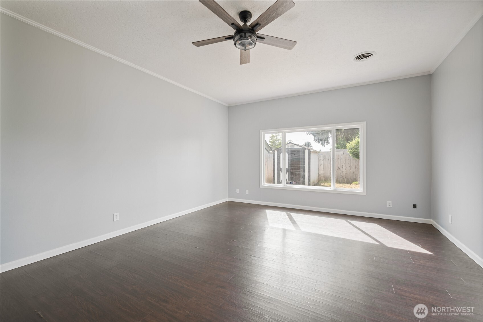 2017 28th Avenue Longview, WA 98632 - Photo 16 of 37 an empty room with wooden floor fan and windows