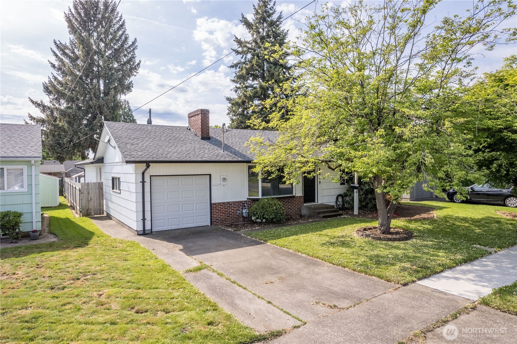 2017 28th Avenue Longview, WA 98632 - Photo 3 of 37 a front view of a house with a yard and large tree