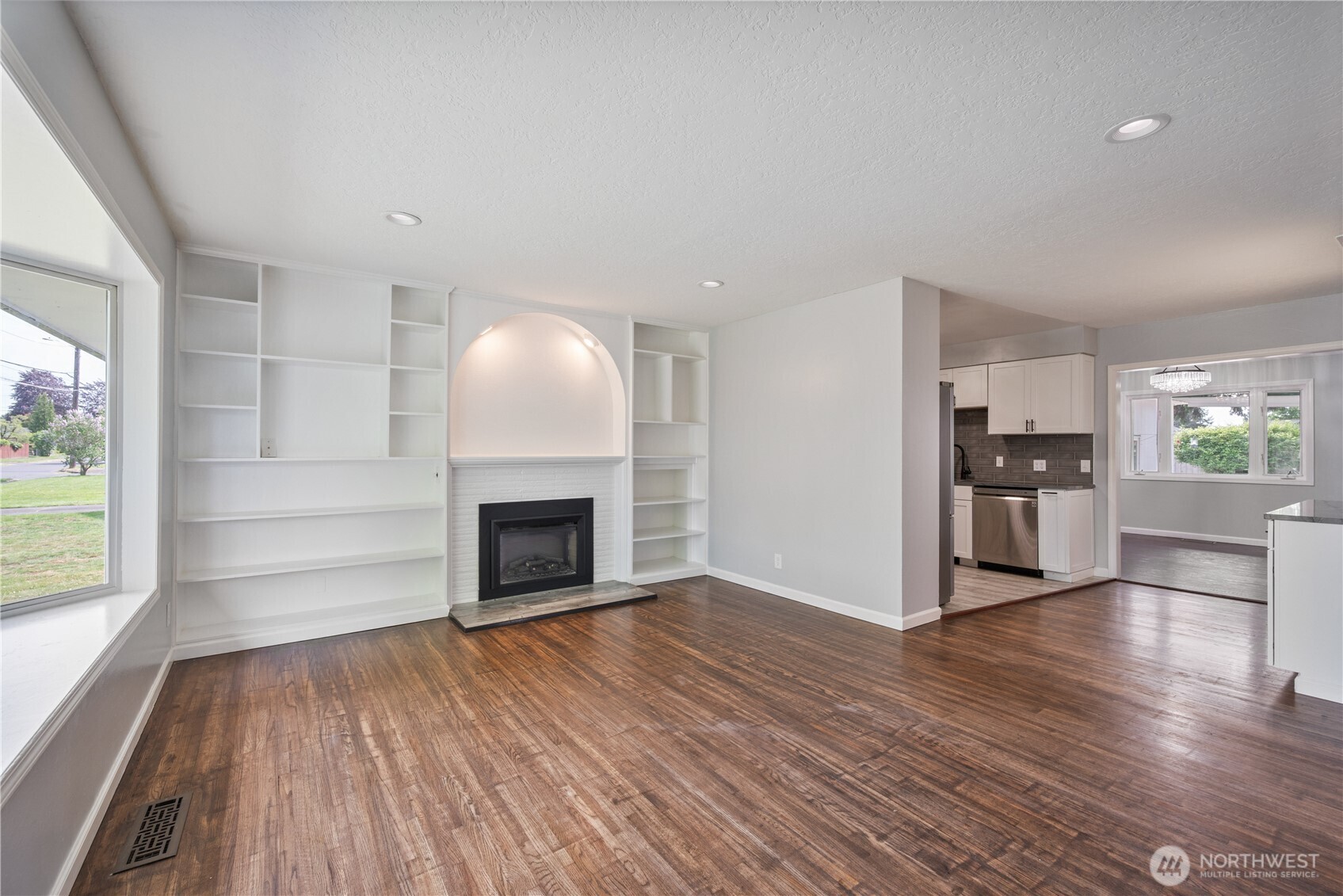 2017 28th Avenue Longview, WA 98632 - Photo 4 of 37 a view of a kitchen with wooden floor and a fireplace