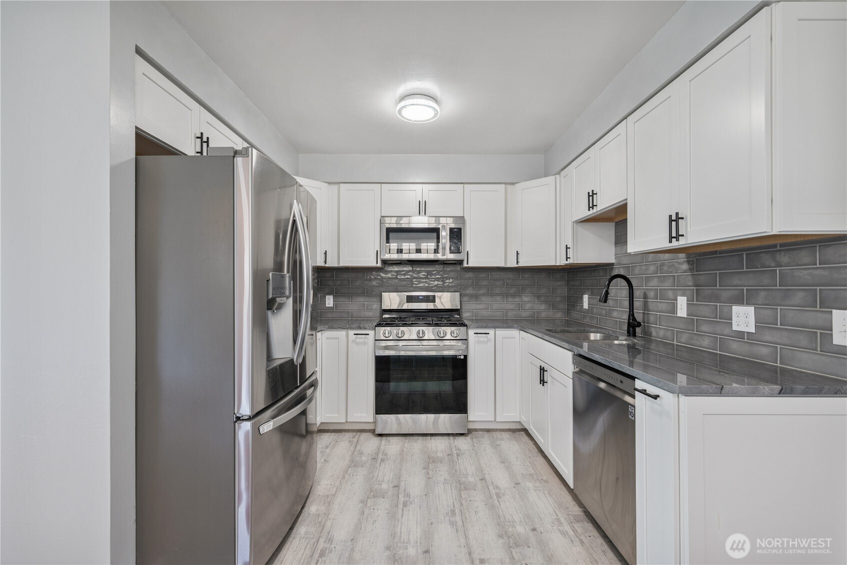 2017 28th Avenue Longview, WA 98632 - Photo 9 of 37 a kitchen with stainless steel appliances granite countertop a refrigerator stove and sink