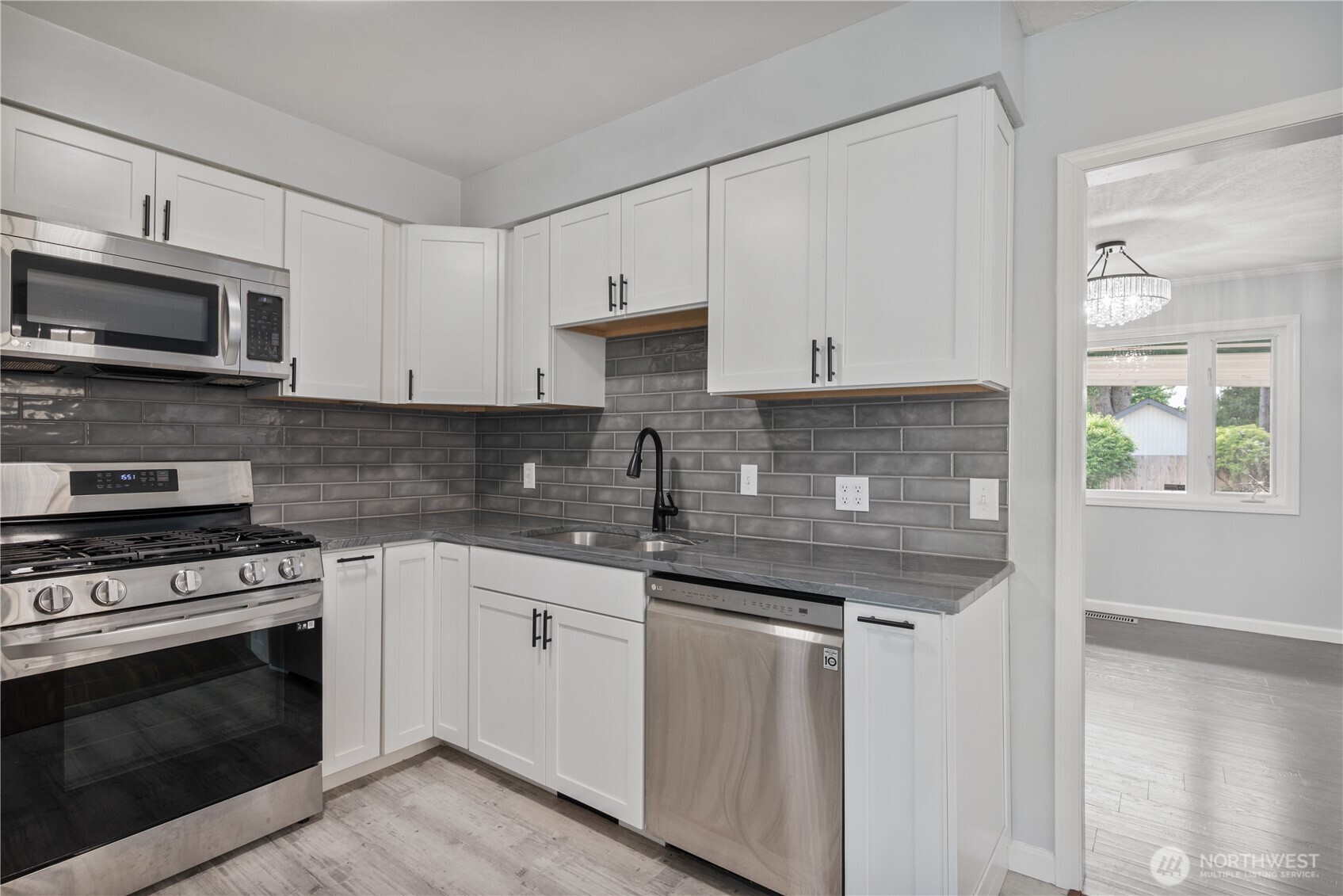 2017 28th Avenue Longview, WA 98632 - Photo 10 of 37 a kitchen with stainless steel appliances granite countertop a stove a sink and a microwave