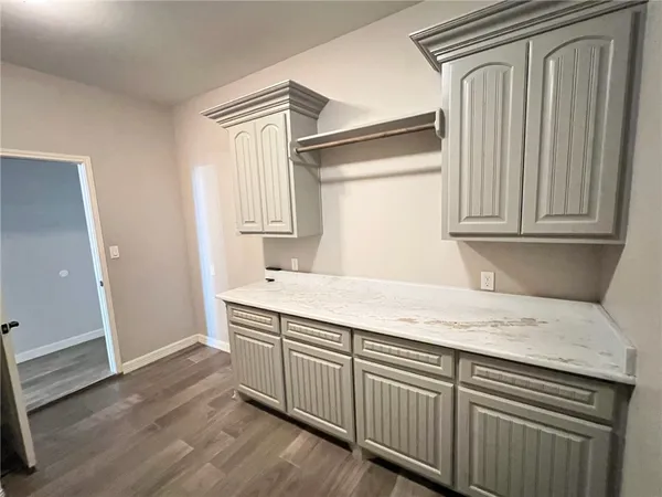 en empty room with wooden floor and ceiling fan