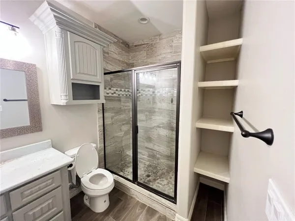 a bathroom with a sink mirror and toilet